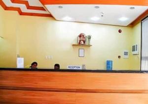 two people sitting at a reception desk in a waiting room at JL Suites by Hiverooms in Cebu City