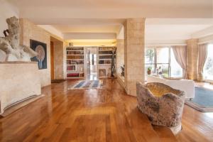 a large living room with a couch and a chair at Majestique Villa Aegina in Egina