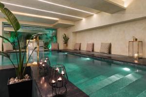 a swimming pool in a hotel with chairs at Athenaeum Eridanus Luxury Hotel in Athens