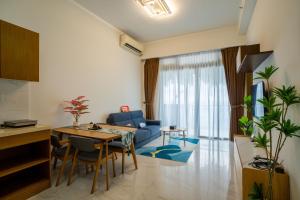 a living room with a blue couch and a table at Best Hotel in Johor Bahru