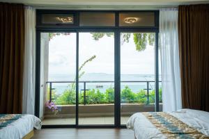 a bedroom with a large glass door leading to a balcony at Best Hotel in Johor Bahru +79 photos