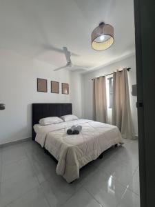 a bedroom with a large bed with a black headboard at Duchess Home Taman Colonial in Raub +13 photos