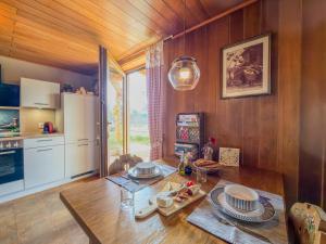a kitchen with a wooden table and a refrigerator at Einfach bei uns in Fresach