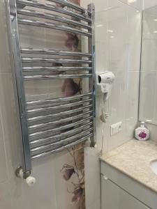 a bathroom with a towel rack on the wall at Wave Inn boutique in Yerevan +22 photos