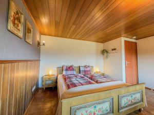 a bedroom with a bed with a wooden ceiling at Einfach bei uns in Fresach +51 photos