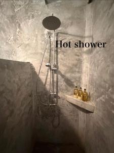 a shower in a bathroom with a hot shower at Groovy Bungalows Koh Phayam in Ko Phayam +9 photos