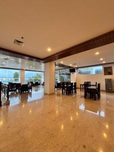 a dining room with tables and chairs in a building at Zam Hotel By Pavotel in Kedungbadak