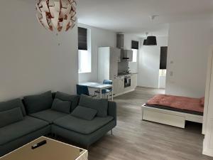 a living room with a couch and a kitchen at LuxAppartement Trier in Trier
