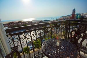 a table on a balcony with a view of the ocean at Hotel Kim Thái in Phú Quốc