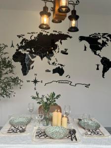 a table with a map of the world on a wall at Duchess Home Taman Colonial in Raub