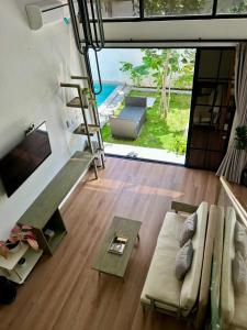 a living room with a couch and a view of the ocean at Gauri Vasanta Villa with Private Pool Yogyakarta in Yogyakarta