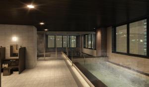 a large swimming pool in a building with a pool at HOTEL AMANEK Kumamoto in Kumamoto