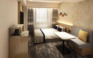 a hotel room with a bed and a desk at HOTEL AMANEK Kumamoto in Kumamoto