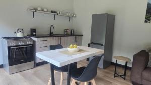 a kitchen with a table with a bowl of fruit on it at Tranquility - Cabin nestled in the mountains in Worcester