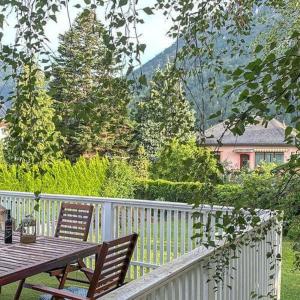 a wooden table and two chairs on a balcony at Garden Lodge Minou in Hirschwang