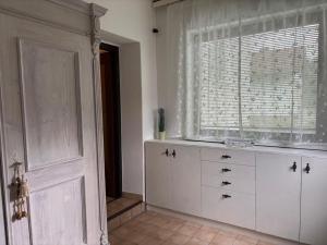 a room with a white dresser and a window at Garden Lodge Minou in Hirschwang +14 photos
