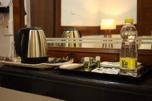 a table with a bottle of drink and a coffee maker at SVS Grand in Dindigul