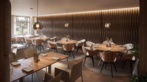 a dining room with wooden tables and chairs at Butični Hotel Sončno Polje in Moravske-Toplice