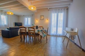 a living room with a table and chairs and a couch at Le marguette in Poivres