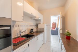 a kitchen with a sink and a counter top at Les Géraniums - Maison avec terrasse - Baden in Baden +8 photos