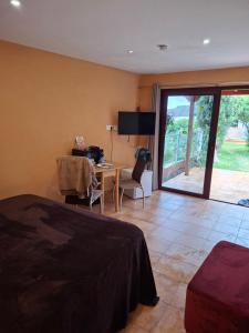 a bedroom with a bed and a desk and a table at Wonderland Villa Tierra Fértil Los Gigantes in Santiago del Teide