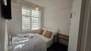 a small bedroom with a bed and a window at Nice Living Serviced Accommodations 15 in Allesley