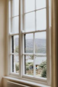 an open window with a view of a house at Y Pengwern in Ffestiniog