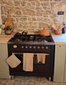 a black stove with a pot on top of it at L'Amour Toujours in Saint-Julien-le-Petit