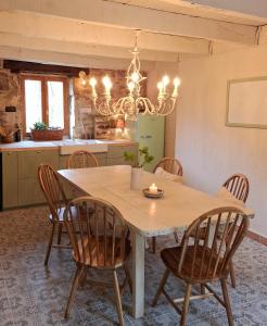 a kitchen with a dining room table and chairs at L'Amour Toujours in Saint-Julien-le-Petit