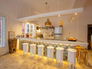 a kitchen with a bar with stools at Palais Laila in Tighfert +36 photos