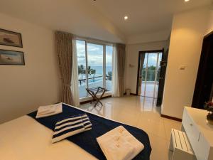 a bedroom with a bed with a view of the ocean at Royal Wave, Beachfront, Nilaveli in Trincomalee +114 photos