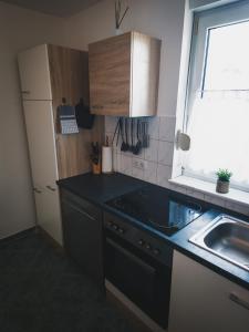 a kitchen with a black counter top and a sink at Ferienwohnung Nauen in Nauen