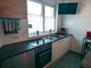 a small kitchen with a sink and a window at Ferienwohnung Nauen in Nauen