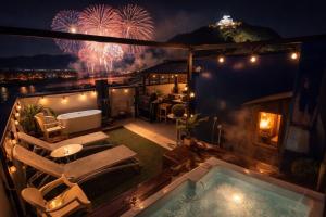 a rooftop patio with a hot tub and fireworks at Vacanza gifu sauna villa in Gifu