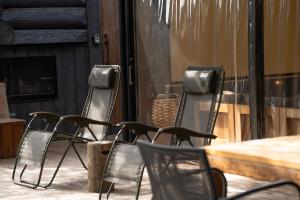 a group of chairs sitting in front of a table at Tiny Base in Kawazu
