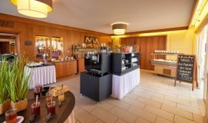 a restaurant with a coffee shop with a counter at Waldhotel Bärenstein in Horn-Bad Meinberg +49 photos