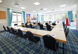 a conference room with long tables and chairs at Waldhotel Bärenstein in Horn-Bad Meinberg