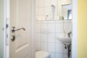 a bathroom with a toilet and a sink at Hotel Eintracht in Fellbach
