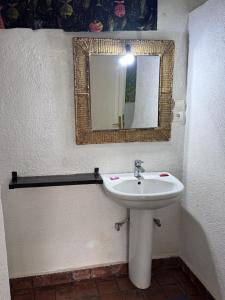a bathroom with a sink and a mirror on the wall at Palm Garden Resort in Gisenyi +58 photos