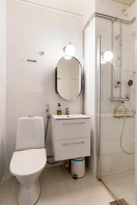 a bathroom with a toilet and a sink and a shower at Funky City Apartment By Lapland Host in Rovaniemi +7 photos