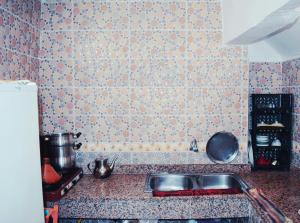 a kitchen with a sink and a counter top at Taghazout Surf House in Taghazout
