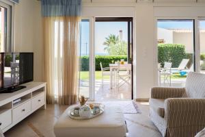 a living room with a tv and a couch at Villa Avra in Panormos Rethymno