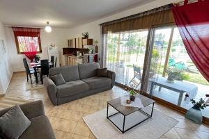 a living room with a couch and a table at Finikas Garden Home in Karianí