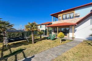 a house with a patio and palm trees at Finikas Garden Home in Karianí