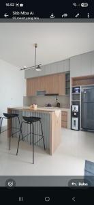 a kitchen with a table and two chairs in it at Sukabumi Villa Mochi Private Jacuzzi in Sukabumi