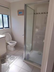 a bathroom with a shower and a toilet at Helens Hideaway in Coronet Bay