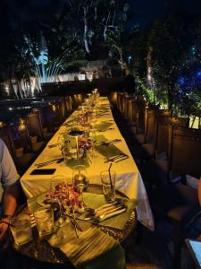 a long table with wine glasses and napkins on it at IYARA b in Ban Map Khangkhao