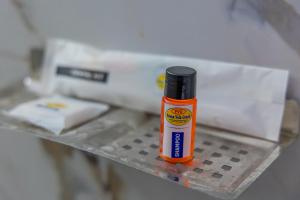 a bottle of glue is sitting on a shelf at P V Grand in Dindigul +56 photos