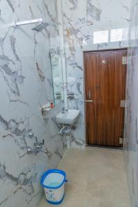 a bathroom with a sink and a toilet at P V Grand in Dindigul