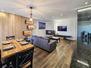 a living room with a couch and a table at Ocean Breeze - Comfortable Ap Close to the Beach in Bicas